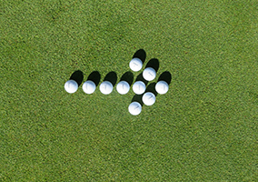 golf balls in a shape of an arrow pointing right